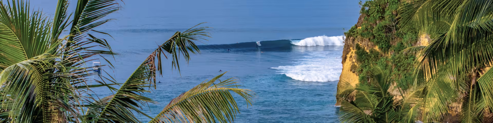 Surfer riding a turquoise wave