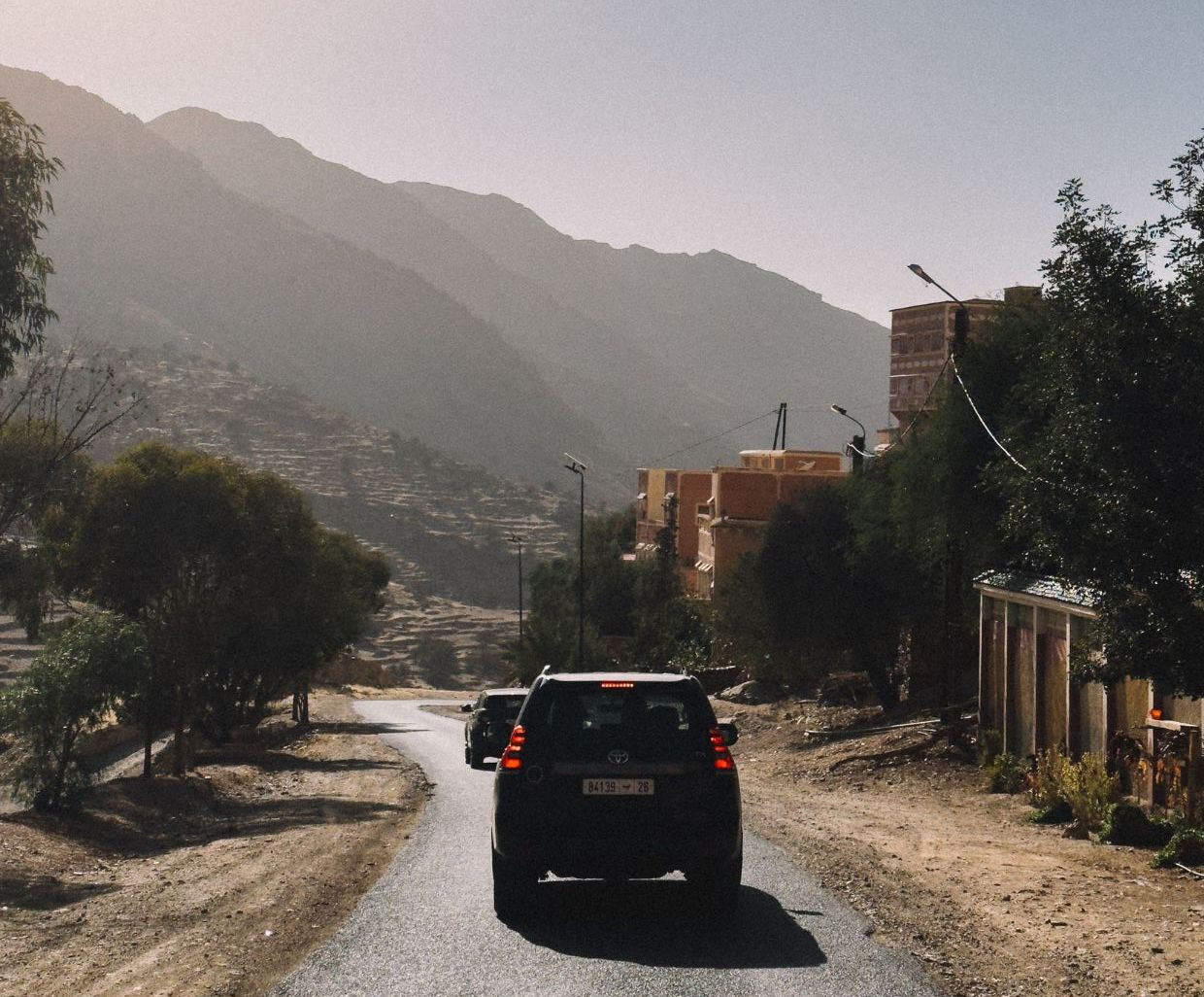 Two black cars driving through the mountains in Morocco
