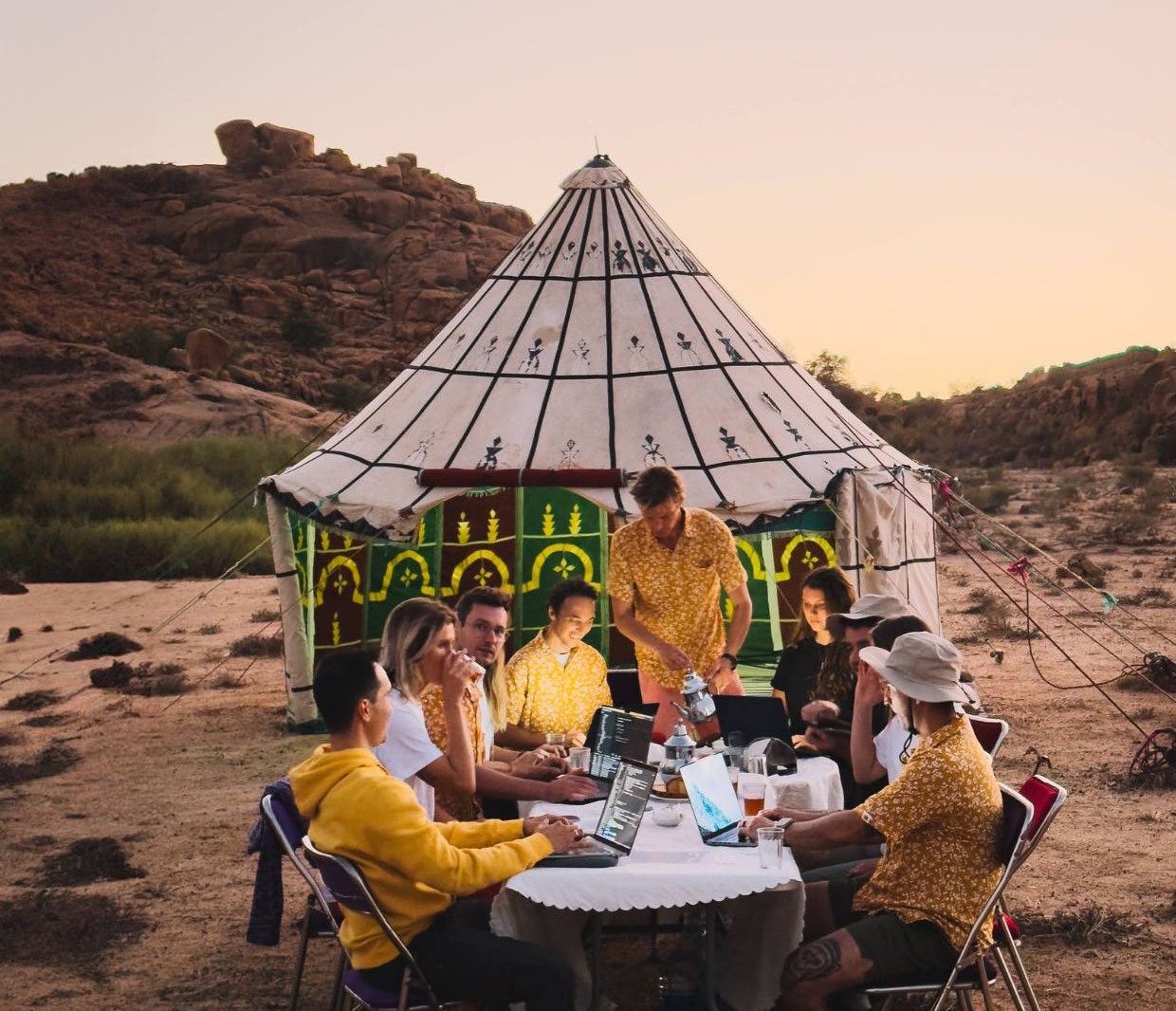 The Bookinglayer team working on laptops in the desert. 